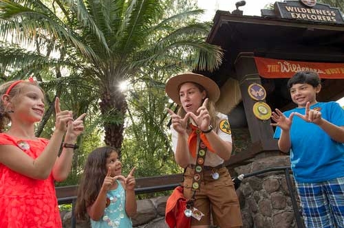 Kids at the starting point of the Wilderness Explorers being helped by a Disney Explorer Guide